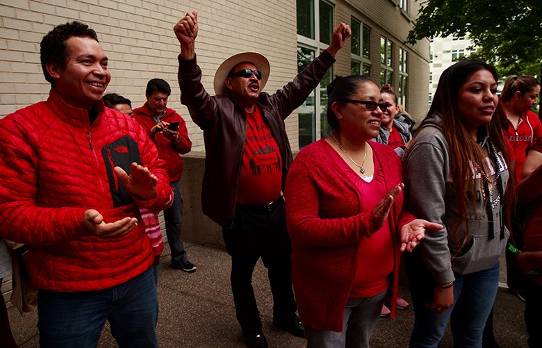 Cruz Medina, center, celebrates outside of Maleng Regional Justice Center in Kent, Wash. Thursday, June 7, 2018 in Kent, Wash. Medina and members of the Firs Homeowners Association applauded a judge’s decision preventing Firs Mobile Home Park residents from being immediately evicted.