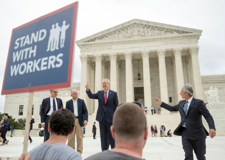 CORRECTS LEFT TO RIGHT – Illinois Gov. Bruce Rauner gives a thumbs up outside the Supreme Court, Wednesday, June 27, 2018 in Washington. From left are, Liberty Justice Center’s Director of Litigation Jacob Huebert, plaintiff Mark Janus, Rauner, and Liberty Justice Center founder and chairman John Tillman.  The Supreme Court ruled Wednesday that government workers can’t be forced to contribute to labor unions that represent them in collective bargaining, dealing a serious financial blow to organized labor.   (AP Photo/Andrew Harnik)