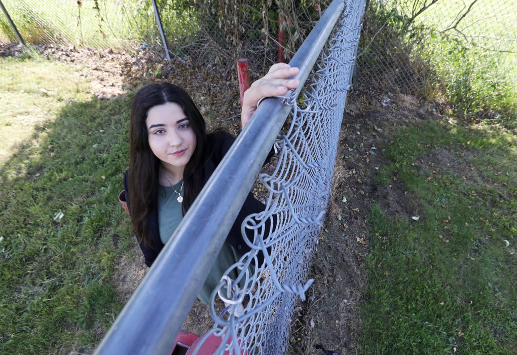 Susana Barbosa and dozens of other students escaped over this fence on the day of the shooting. (Ken Lambert/The Seattle Times)
