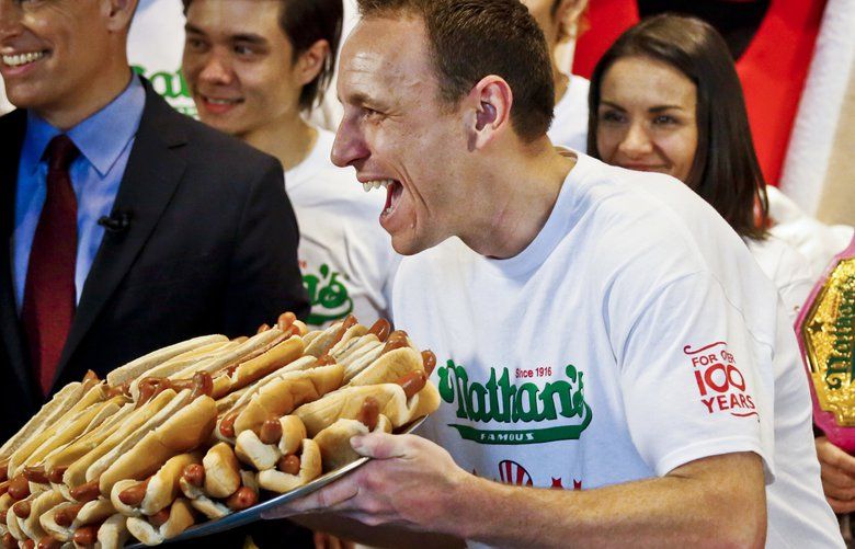 Defending Nathan’s Famous Men’s Champion Joey Chestnut, center, shows off a plate of hotdogs along with women’s world champion Miki Sudo, right, during a weigh-in ceremony forNathan’s Famous International Fourth of July Hot Dog Eating Contest, Tuesday, July 3, 2018, in New York. (AP Photo/Bebeto Matthews) NYBM109 NYBM109