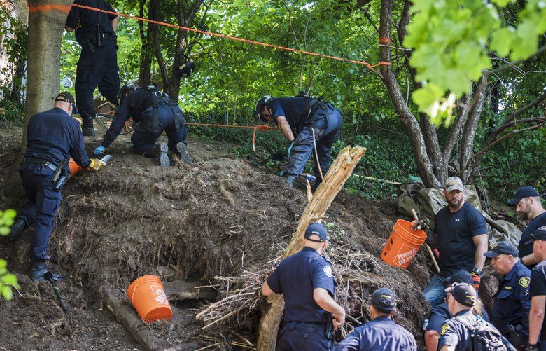 Members of the Toronto Police Service excavate the back of a property in Toronto during an investigation in relation to alleged serial killer Bruce McArthur on Thursday, July 5, 2018. More human remains have been discovered behind a home where McArthur worked as a landscaper. (Tijana Martin/The Canadian Press via AP) TIJ103 TIJ103