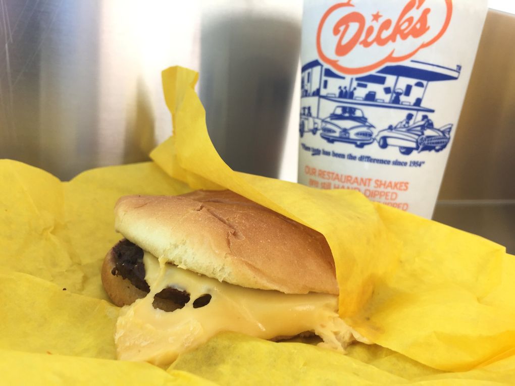 The cheeseburger at Dick’s is perfection to Bethany… Tan, not so into it. (Bethany Jean Clement / The Seattle Times)