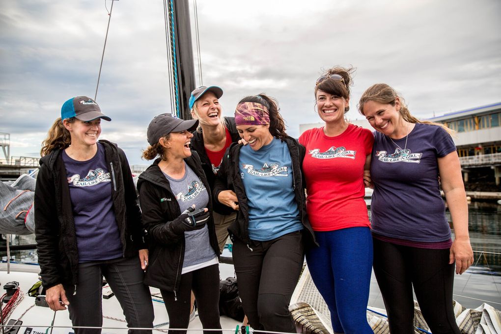 From Left: Haley Lhamon, Anna Stevens, Aimee Fulwell (back), Jeanne Goussev, Allison Dvaladze, and Kelly Danielson laugh while wearing their “Sail Like a Girl” team shirts in the Bell Harbor Marina on July 9. They are six members of the eight-woman team that recently won a boat race from Port Townsend to Ketchikan, Alaska. (Rebekah Welch / The Seattle Times)