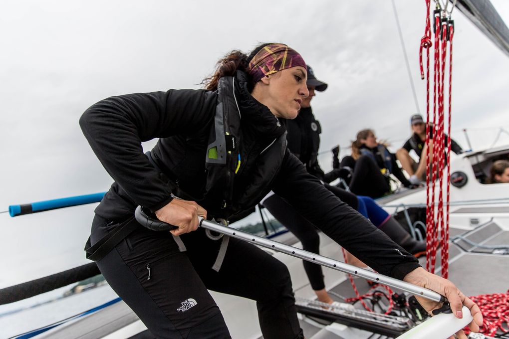 Jeanne Goussev, co-captain and owner of the Melges 32 that the team used in the race, keeps her post at the helm as the team tacks, or turns the bow of the boat to the wind. (Rebekah Welch / The Seattle Times)