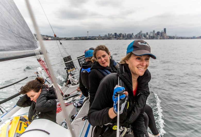 Kelly Danielson (back) and Aimee Fulwell look out over Puget Sound while they and few of their teammates revisit the boat they victoriously sailed from Port Townsend to Ketchikan, Alaska. The all-female crew won the 750-mile nonmotorized race.  (Rebekah Welch / The Seattle Times)