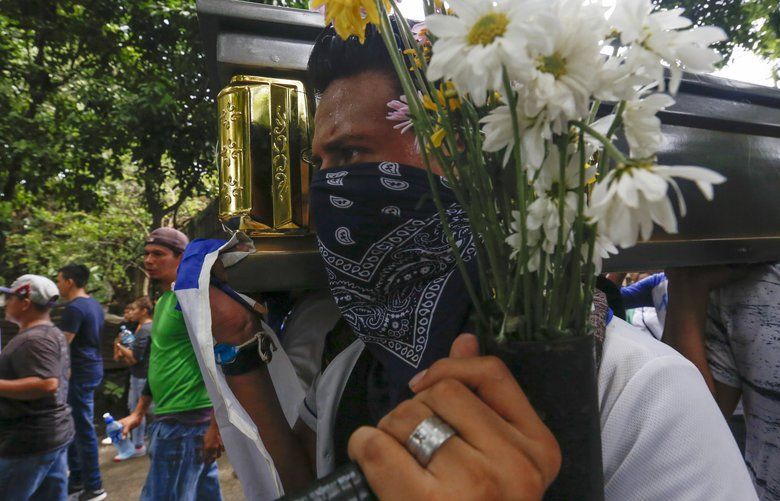 Friends and family carry the coffin with the body of Gerald Vasquez, an engineering student who was killed during the July 14 attack by police and paramilitary forces to the National University of Managua, to be buried in Managua, Nicaragua, Monday, July 16, 2018. The onslaught was televised by local media outlets and covered by three local journalists who reported via Facebook Live. Students fearing for their lives sent farewell messages to friends and family. “I did it for the country and I don’t regret it,” a crying girl said in a video that went viral. “Forgive me mama, I love you.” (AP Photo/Alfredo Zuniga) XNIC120 XNIC120