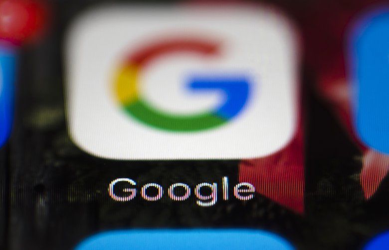 FILE  – This Wednesday, April 26, 2017 file photo shows a Google icon on a mobile phone(AP Photo/Matt Rourke, File) 