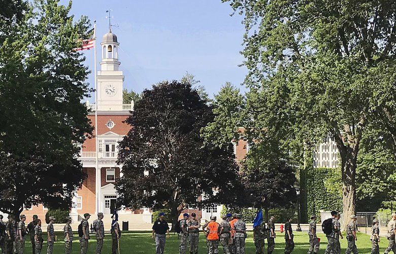 In this Monday, July 16, 2018 photo, students from the Corps of Cadets march in front of Jackman Hall, rear, on the campus of Norwich University in Northfield, Vt. Norwich has become the latest school to offer income share agreements, where colleges receive a percentage of the student’s future salary, in place of some student loans. (AP Photo/David Jordan) RPDJ201 RPDJ201