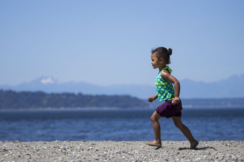 Linell Jackson of Lakewood enjoys the beach on her third birthday at Seahurst Park in Burien Sunday, July 15. (Bettina Hansen / The Seattle Times)