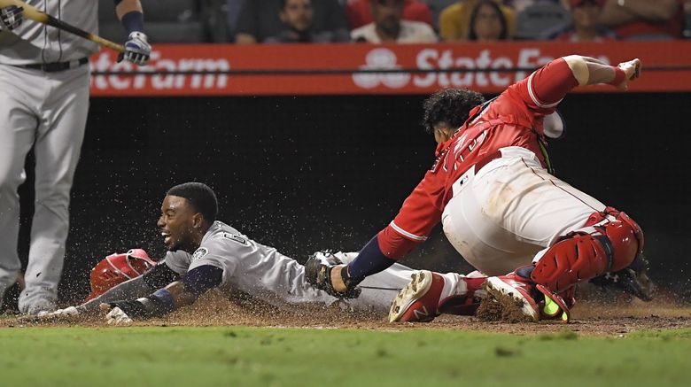 Kole Calhoun scores on wild pitch to push Angels past Mariners in