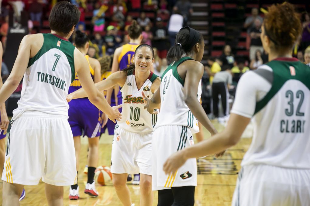 Storm guard Sue Bird fives her teammates, from left, Ramu Tokashiki, Jewell Loyd and Alysha Clark, after the Seattle Storm defeated the Los Angeles Sparks 68-61 at Key Arena in Seattle, Wednesday July 15, 2015. (Bettina Hansen / The Seattle Times)