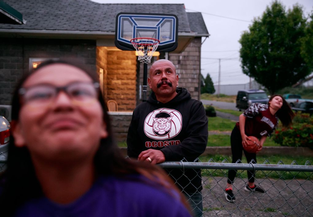 Arainuh, left, her father, Juan Lopez, and her friend Olivia play outside at the Lopez home. “I believe that they need their father in their lives,” mom Erika says of Arainuh and her brother. “He’s such a good father. I can’t imagine them having their life without him.” (Erika Schultz/The Seattle Times)