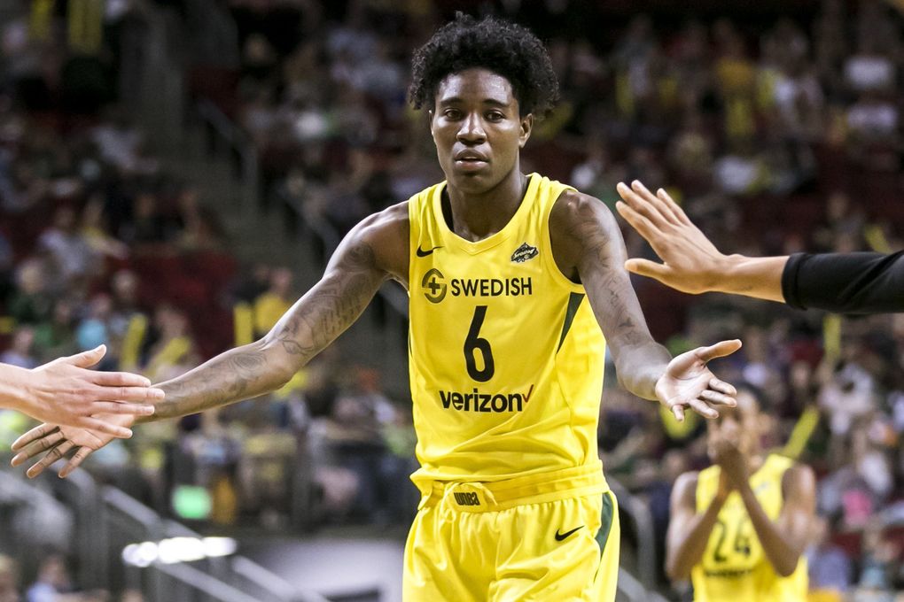 Seattle forward Natasha Howard gets fives after scoring her 1,000th career point on a free throw in the second half. (Bettina Hansen / The Seattle Times)
