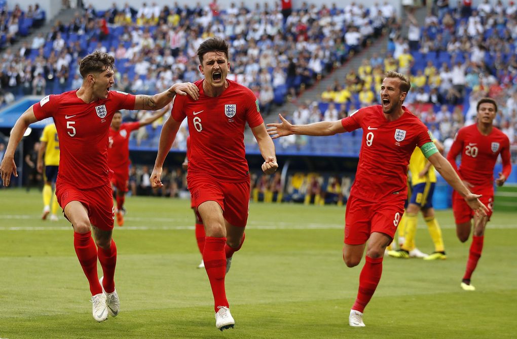 England’s Harry Maguire, center, celebrates with his teammates after scoring the opening goal of their 2-0 quarterfinal win over Sweden at the 2018 World Cup. (Francisco Seco / The Associated Press)