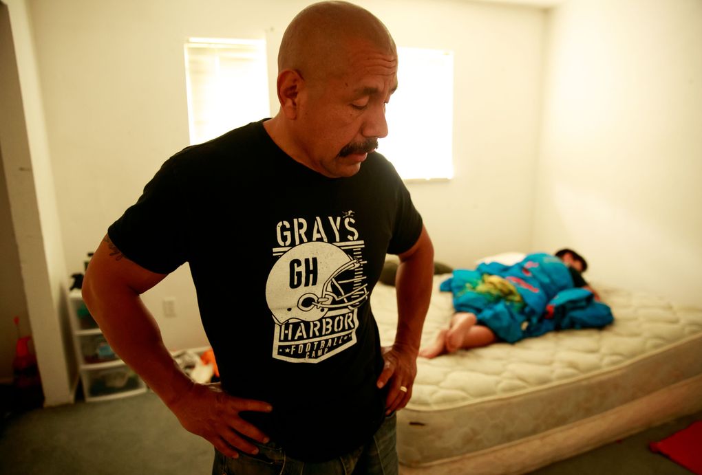 Juan Lopez walks through his son’s bedroom. They were packing up their belongings, and much of the house was bare. (Erika Schultz/The Seattle Times)
