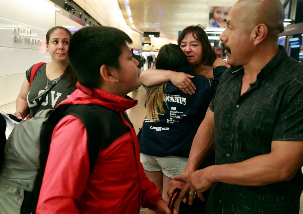 Erika, far left, looks at husband Juan as the Lopez family says goodbye to Erika’s mom, Linda Cazier. (Erika Schultz/The Seattle Times)
