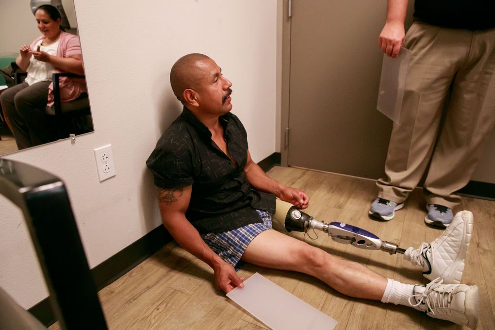 Juan Lopez receives an adjustment to his prosthetic leg. “One of my biggest fears is the medical situation,” says Erika, concerned that her husband might not get the same care in Mexico. (Erika Schultz/The Seattle Times)