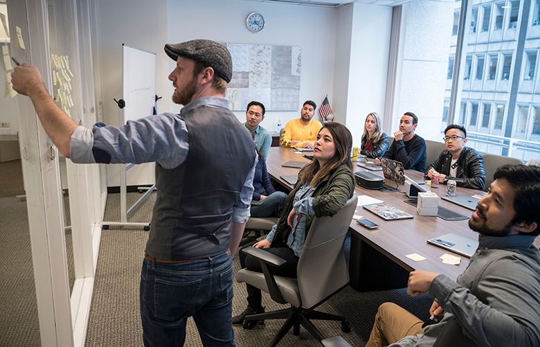Workers at Eaze, a marijuana delivery service based in San Francisco, gather for a “design sprint,” a workplace tactic that comes from Silicon Valley. Jeffrey Erikcson leads the discussion. (David Butow/Los Angeles Times/TNS)