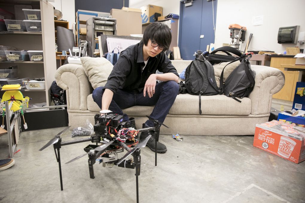 Jeonghyun Kress shows the team’s six-propeller drone. It will be flown by a pilot while a gunner operates the turret, which shoots marble-sized pellets at the opposing team’s robots. (Bettina Hansen/The Seattle Times)