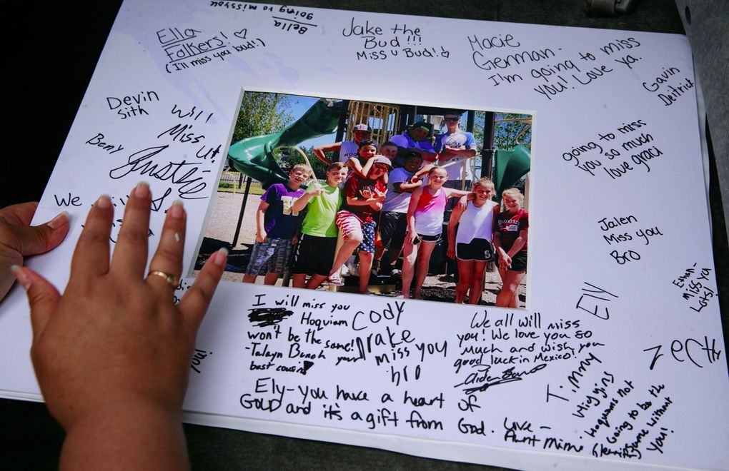 Friends write goodbye messages on a photograph for Elyjuh’s 13th birthday. (Erika Schultz/The Seattle Times)