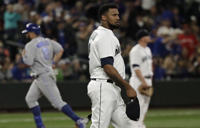 Seattle Mariners pitcher Juan Nicasio center, waits as Toronto Blue Jays’ Kendrys Morales, left, rounds the bases after hitting a two-run home run during the seventh inning of a baseball game Thursday, Aug. 2, 2018, in Seattle. (AP Photo/Ted S. Warren) WATW122 WATW122