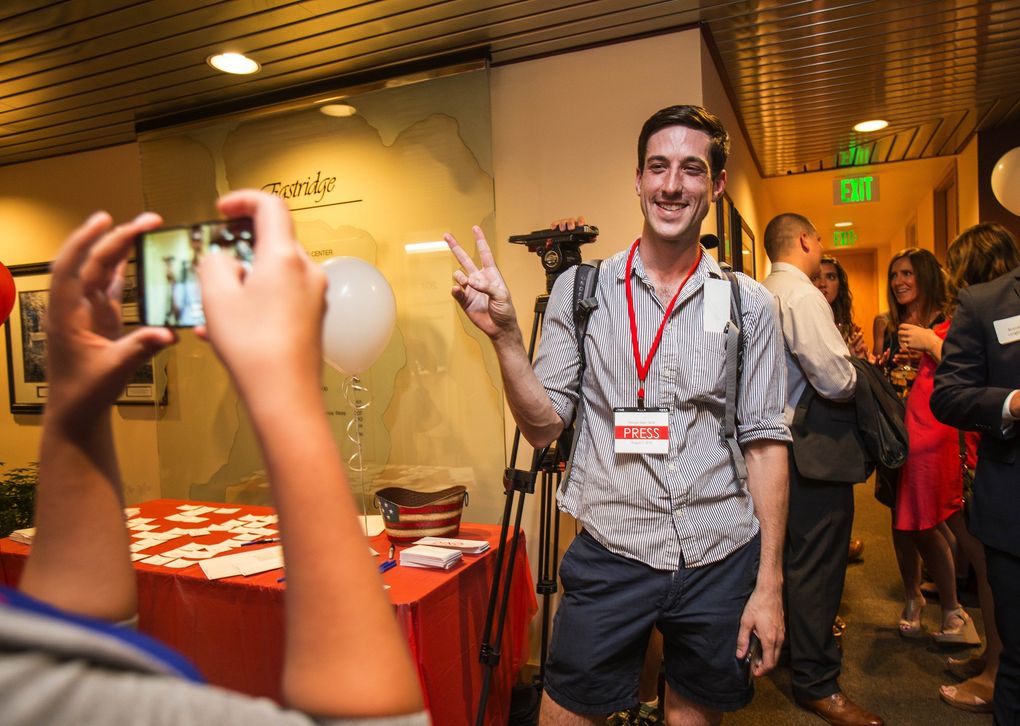 A reporter for The Stranger enters the State Republican Party headquarters after initially being asked to leave. (Dean Rutz / The Seattle Times)