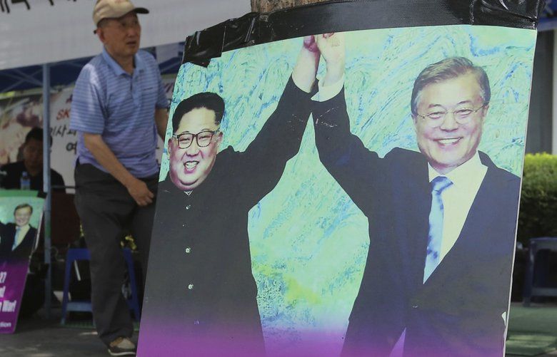 Photos showing North Korean leader Kim Jong Un, left, and South Korea President Moon Jae-in are displayed to demand withdrawal of U.S. troops from Korean Peninsula near the U.S. Embassy in Seoul, South Korea, Monday, Aug. 13, 2018. A senior North Korean official suggested Monday that the leaders of North and South Korea may meet in Pyongyang, as envoys from the rival nations discussed setting a summit date and venue amid an ongoing nuclear standoff. The signs read: “Withdrawal of U.S. troops.” (AP Photo/Ahn Young-joon) SEL108 SEL108