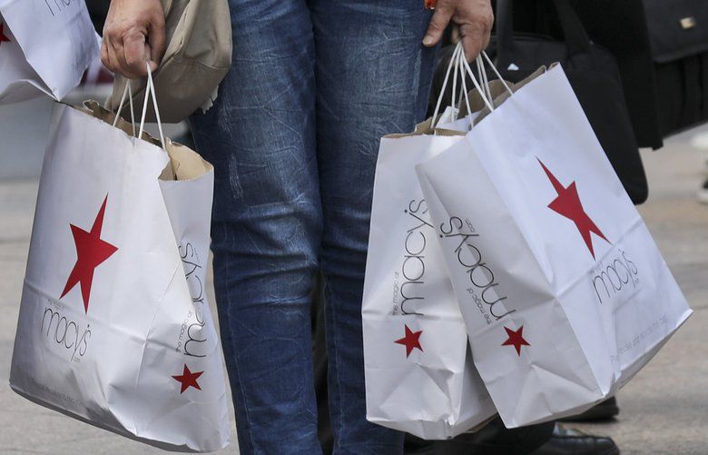 Shoppers holding bags from Macy’s  (AP Photo/Bebeto Matthews, File) 