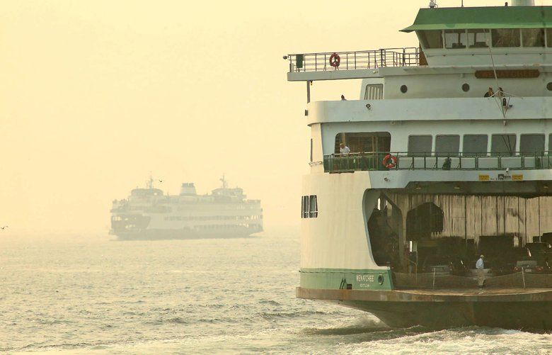 Tuesday August 14, 2018, smoky haze envelopes tour boats and ferries from Bremerton and Seattle.
The Bremerton ferry Walla Walla, left, arrives in Seattle as the ferry Wenatchee, right, departs for Bainbridge Island. 207428