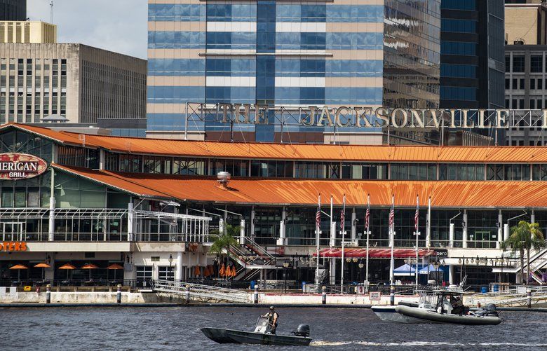 The Coast Guard patrols the St. Johns River outside The Jacksonville Landing in Jacksonville, Fla., Sunday, Aug. 26, 2018. Florida authorities are reporting multiple fatalities after a mass shooting at the riverfront mall that was hosting a video game tournament. (AP Photo/Laura Heald) FLLH101 FLLH101