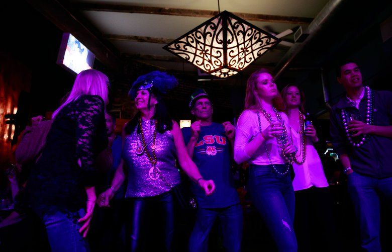 Crowds dance to The Meter Maids at the Royal Room Shack during the annual Columbia City Beatwalk Fat Tuesday Celebration in Seattle Tuesday, Feb. 13, 2018.
 205239
