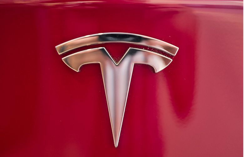 Tesla emblem is seen on the back end of a Model S  (AP Photo/Richard Vogel, File)