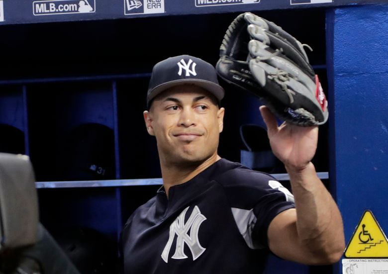 New York Yankees' Giancarlo Stanton walks to the dugout after