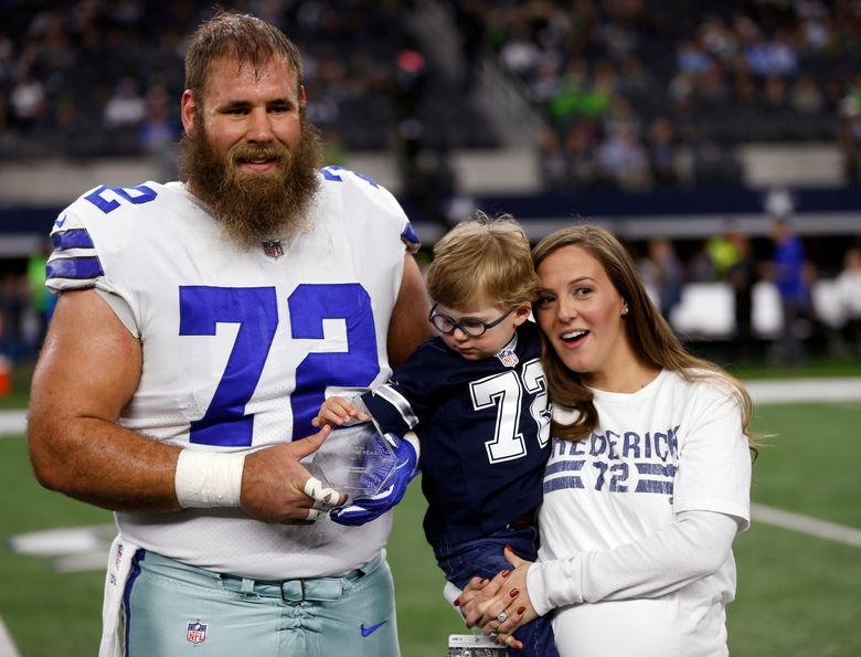 FILE – In this Dec. 24, 2017, file photo, Dallas Cowboys center Travis Frederick (72), and his wife Kaylee, right, pose for a photo as their son Oliver, reaches out to the NFL Man of the Year team nominee award presented to Frederick before an NFL football game against the Seattle Seahawks, in Arlington, Texas. Frederick’s revelation that he is battling a rare neurological disorder will reverberate on and off the field for the Dallas Cowboys. They’re likely to begin the season without their stalwart at center, and without knowing what will happen with their teammate’s recovery. (AP Photo/Ron Jenkins, File)