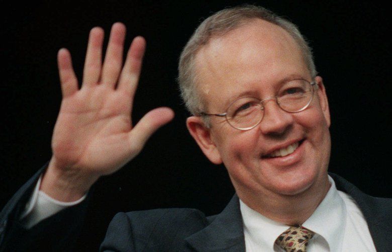 Special prosecutor Ken Starr waves as he enters his car outside his home in McLean, Va. Thursday July 16, 1998. President Clinton’s Secret Service lead agent, Larry Cockell, has entered federal court in Washington to appear before the grand jury under subpoena to testify in the Monica Lewinsky investigation. (AP Photo/Khue Bui)