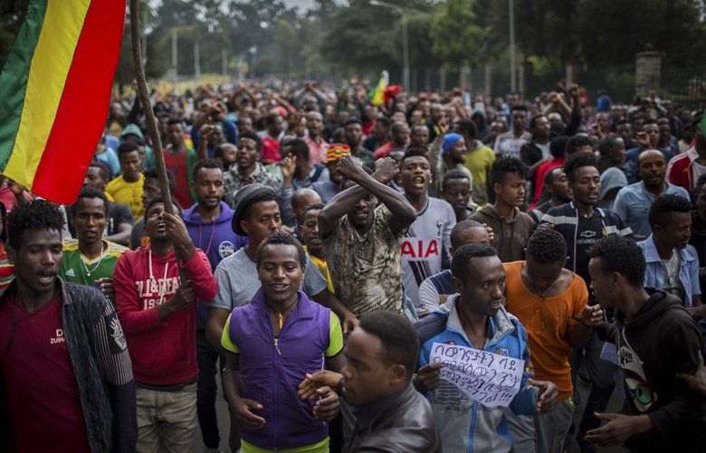 Thousands of protestors from the capital and those displaced by ethnic-based violence over the weekend in Burayu, demonstrate to demand justice from the government in Addis Ababa, Ethiopia Monday, Sept. 17, 2018. Several thousand Ethiopians have gone out onto the streets of the capital to protest ethnic-based attacks in the outskirts of the city in which more than 20 people died over the weekend. Banner in Amharic reads “The government should stop the attacks against our people.” (AP Photo/Mulugeta Ayene) NAI104 NAI104
