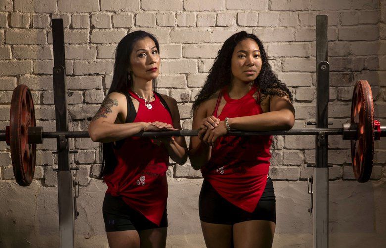 Chisato DuBose, 54, and her daughter Sachie DuBose, 18, are photographed at Columbia City Fitness Center where they train on South Jackson Street. Chisato competes in both powerlifting and bodybuilding. Sachie is a three-time world champion powerlifter. They both are members of the Bull Stewart Powerlifting team.  (Erika Schultz / The Seattle Times)