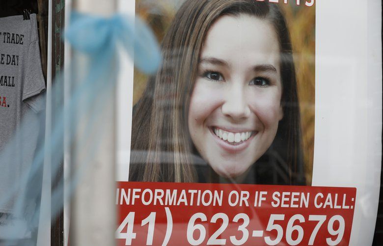 FILE – In this Aug. 21, 2018, file photo, a poster for then missing University of Iowa student Mollie Tibbetts hangs in the window of a local business in Brooklyn, Iowa. Tibbetts was reported missing from her hometown in July after going for a run and her body was found Aug. 21. Recent killings of women who were attacked while engaged in the sports they love have raised questions about how women can defend themselves and why they must be ready to fight off attackers in the first place. (AP Photo/Charlie Neibergall, File) NYCD303 NYCD303