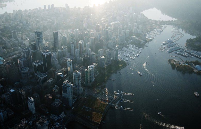 Commercial and residential buildings stand in this aerial photograph taken above Vancouver, British Columbia, Canada, on Thursday, Sept. 6, 2018. Canadian commercial real estate investment reached new heights in the second quarter, boosted by a pair of big acquisitions and by the lure of attractive, income-producing property. Photographer: James MacDonald/Bloomberg 