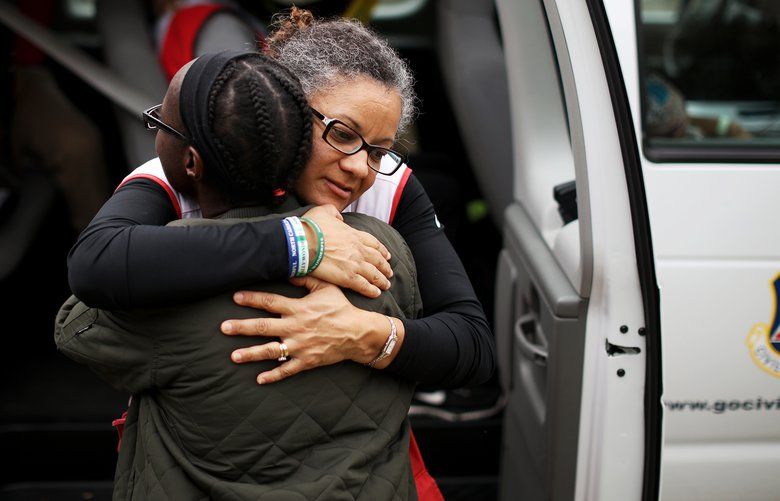 Eve Edwards, in black, a Hurricane Florence evacuee, embraces an American Red Cross  volunteer in Chapel Hill, N.C., Sept. 25, 2018. The storm’s prodigious rainfall continues to swell rivers in the Carolinas, leaving evacuees stuck in shelters and driving more people from their homes. (Travis Dove/The New York Times) XNYT155 XNYT155
