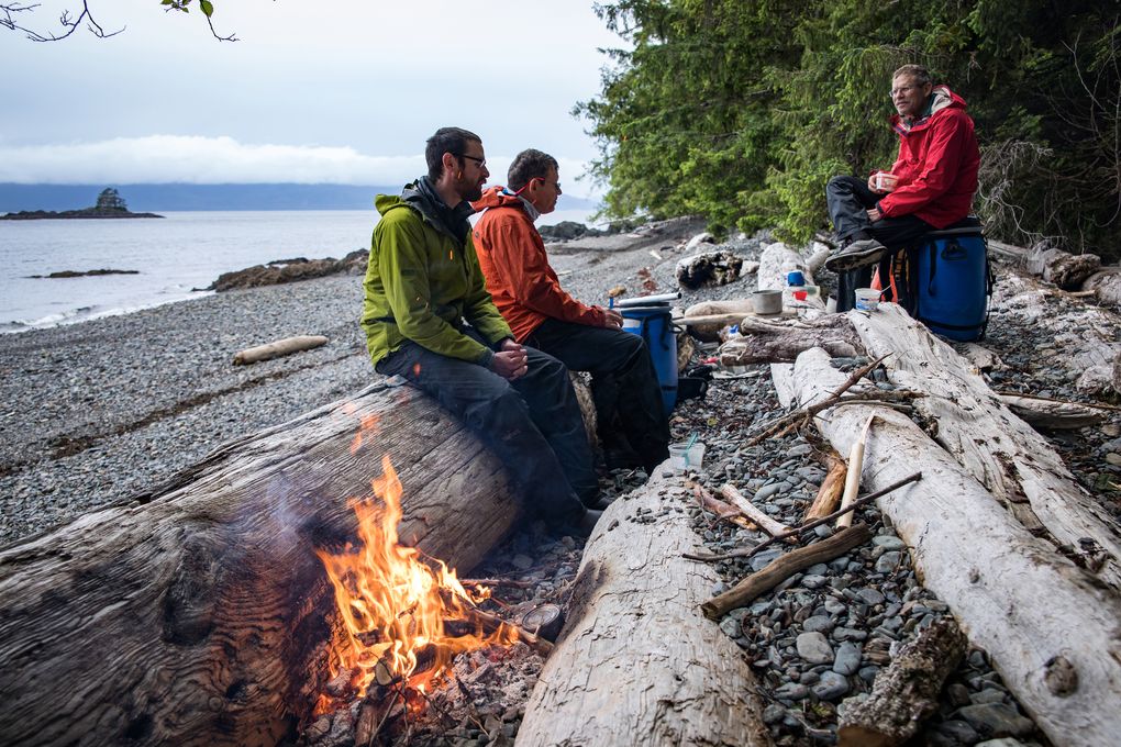 Ben, Alan and Andy Dappen, from left, sit around a campfire at the end of a long day of paddling up the Inside Passage. (Nate Dappen)