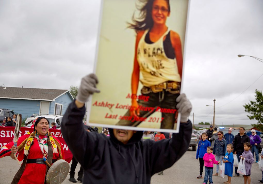Roy Lee HeavyRunner holds a photo of his missing daughter Ashley as Roxanne White, left, yells “Say Her Name” to the crowd as they march in the North American Indian Days parade on the Blackfeet Indian Reservation in Browning, Mont., on July 14. (David Goldman/AP)