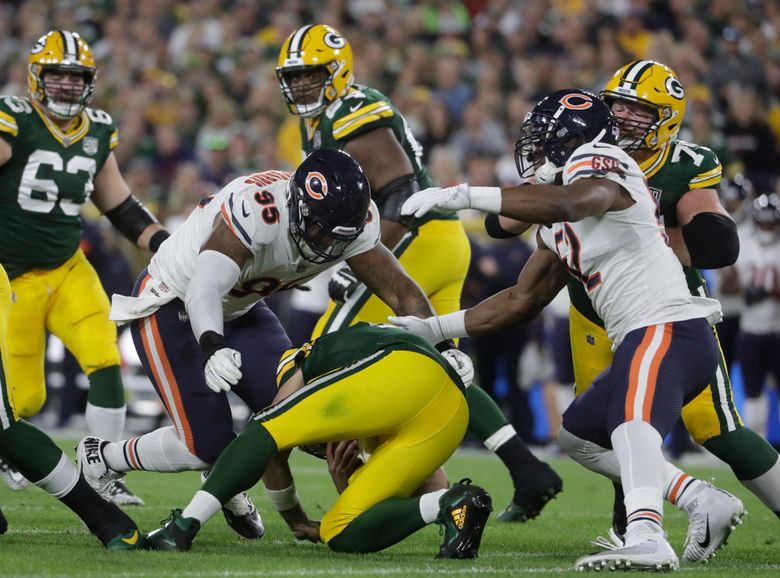 Green Bay Packers Aaron Rodgers takes a knee after being sacked