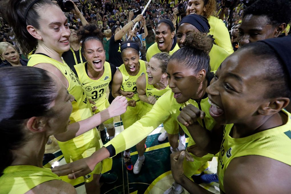 Seattle Storm players gather in a celebratory huddle after a 94-84 win over the Phoenix Mercury during Game 5 of a WNBA basketball playoff semifinal, Tuesday, Sept. 4, 2018, in Seattle. The Storm advanced to the WNBA finals. (AP Photo/Elaine Thompson)