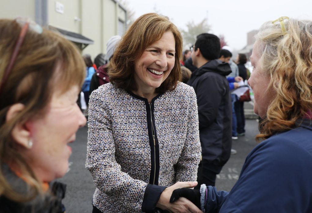 Kim Schrier, center, campaigns for U.S. Congress (WA 8th District), Sunday, Oct. 21, 2018 in Issaquah. (Ken Lambert / The Seattle Times)
