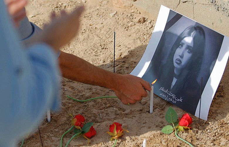 In this Monday, Oct. 1, 2018 photo, fans of slain former beauty queen, fashion model and social media star Tara Fares pray and light candles at her gravesite, in Najaf, Iraq. Fares won fame in conservative, Muslim-majority Iraq with outspoken opinions on personal freedom. Last week, she was shot and killed at the wheel of her white Porsche on a busy Baghdad street. The violence reverberated across Iraq and follows the slaying of a female activist in the southern city of Basra and the mysterious deaths of two well-known beauty experts. (AP Photo/Anmar Khalil) BAG509 BAG509
