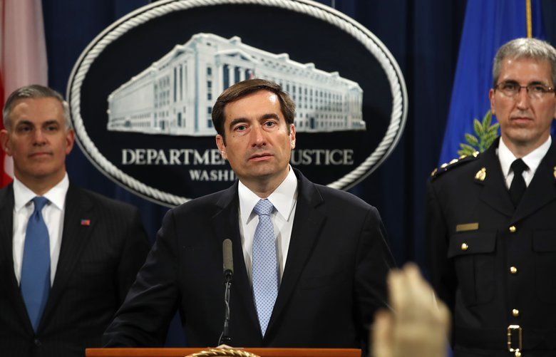 Assistant Attorney General for National Security John Demers, center, answers questions during a news conference, Thursday, Oct. 4, 2018, at the Justice Department in Washington. Demers was joined by U.S. Attorney for the Western District of Pennsylvania Scott Brady, left, and Mark Flynn, Director General for the Royal Canadian Mounted Police. (AP Photo/Jacquelyn Martin) DCJM101 DCJM101