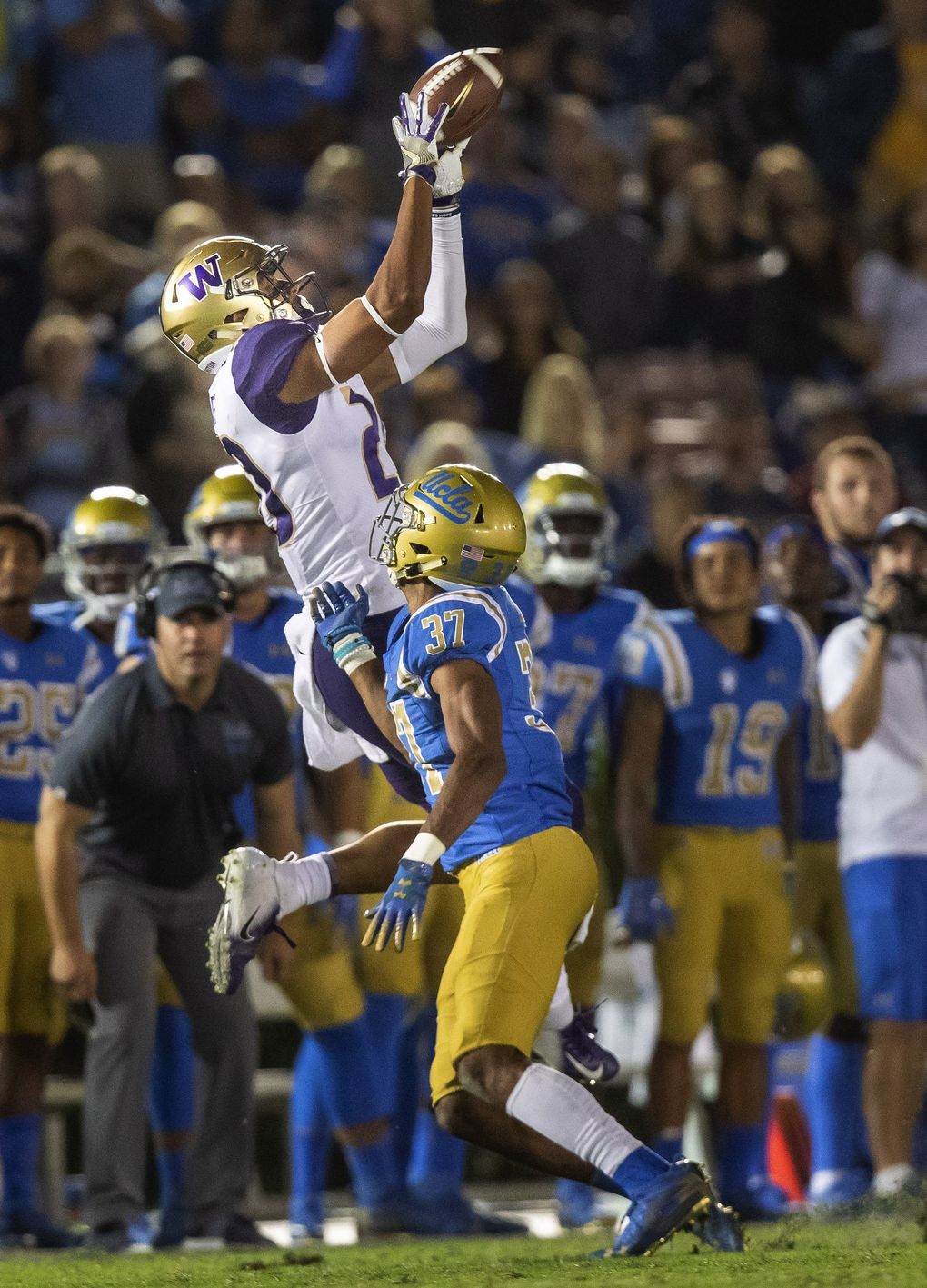 On 3rd and 6 from their own 26-yard line, Jake Browning connects with Ty Jones for a first down at the UCLA 43-yard line. (Dean Rutz / The Seattle Times)