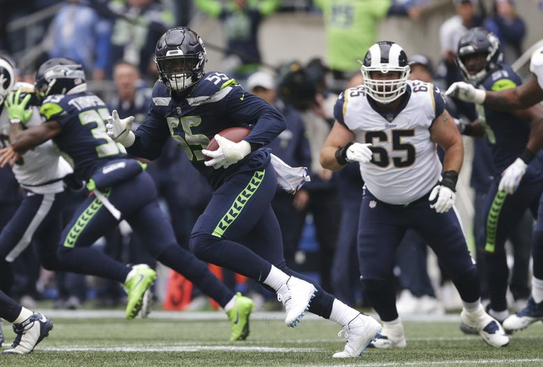 Seattle Seahawks defensive end Frank Clark (55) intercepts a pass intended  for Los Angeles Rams running back Todd Gurley (30) to stop a drive during  the first quarter at CenturyLink Field on