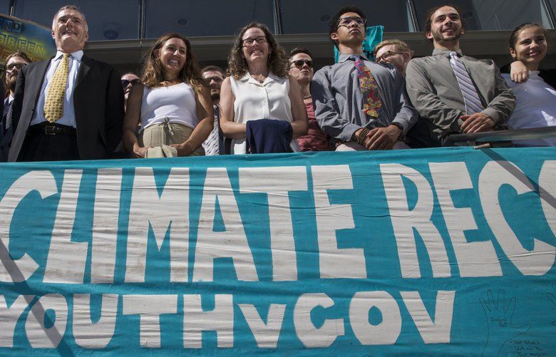 FILE – In this July 18, 2018, file photo, lawyers and youth plaintiffs lineup behind a banner after a hearing before Federal District Court Judge Ann Aiken between lawyers for the Trump Administration and the so called Climate Kids in Federal Court in Eugene, Ore. The U.S. government is trying once again to block a major climate change lawsuit days before young activists are set to argue at trial that the government has violated their constitutional rights by failing to take action climate change. On Thursday, Oct. 18, 2018, the Justice Department for a second time this year asked the U.S. Supreme Court to dismiss the case. The high court in July denied the request as premature. (Chris Pietsch/The Register-Guard via AP, File) OREUG502 OREUG502
